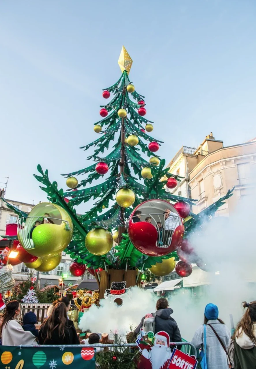 Close view of the carousel base and cabins beneath the Christmas tree