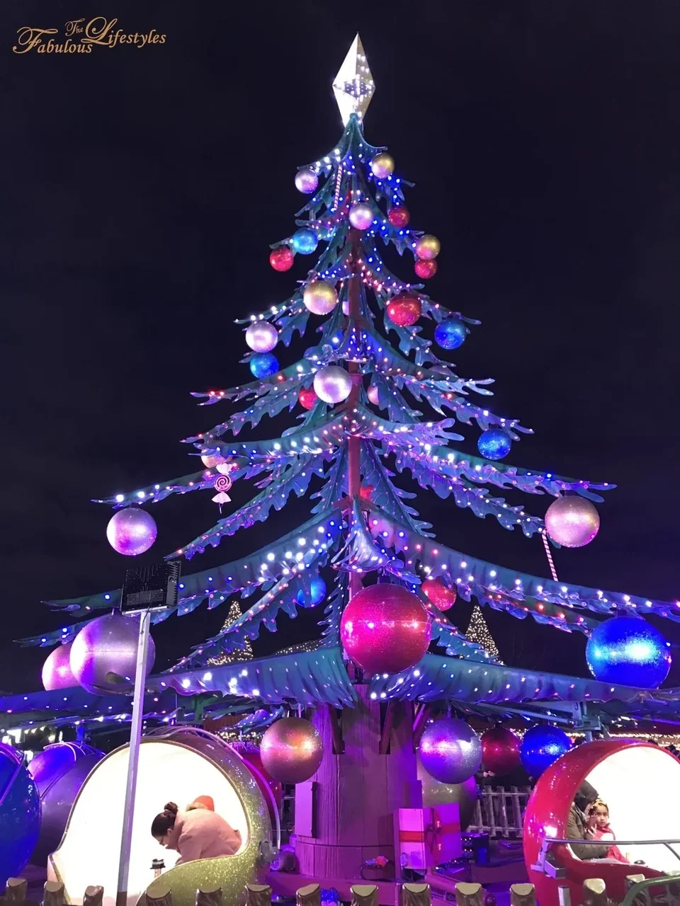 Illuminated Christmas tree ride at night with the tree lights switched on