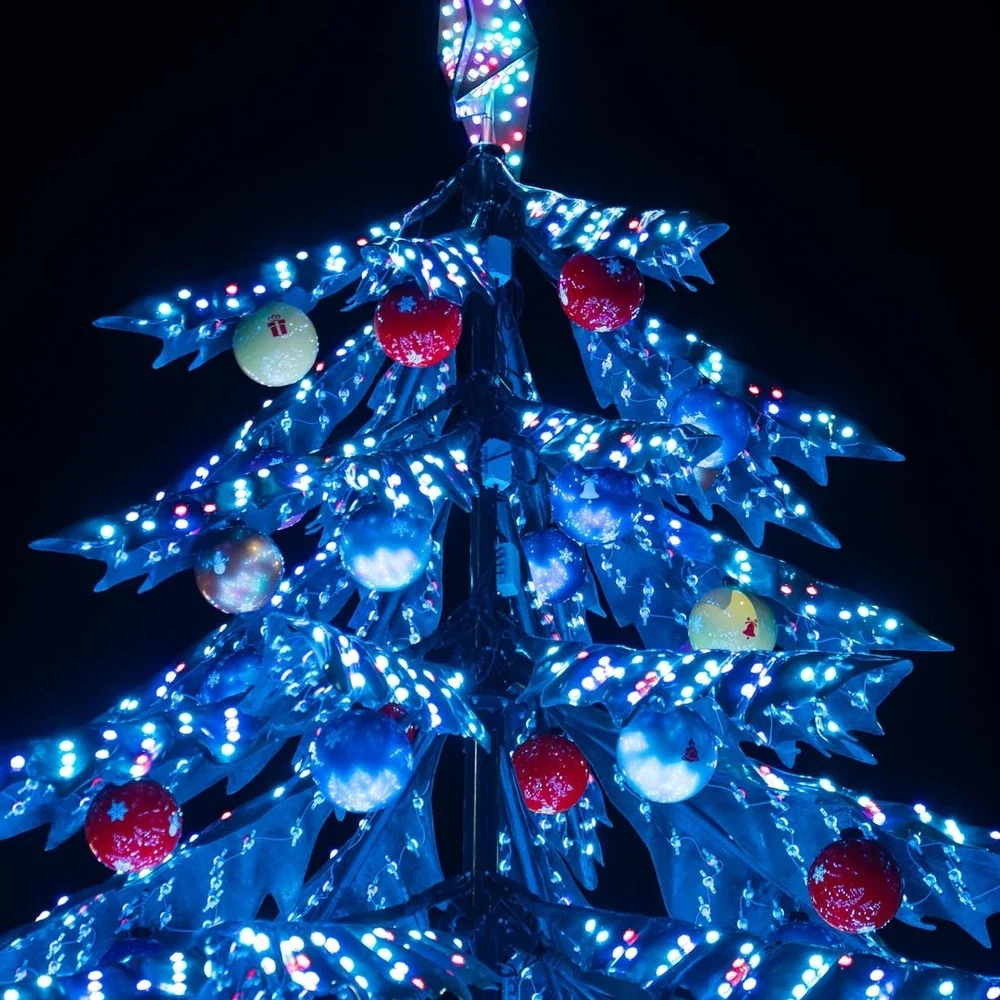 Christmas tree ride with blue illumination on the tree canopy